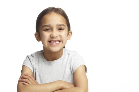 Young girl with missing front tooth on white backgroundの写真素材