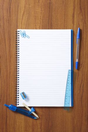 Back to School pupils note pad and stationary on wooden school desk from aboveの写真素材
