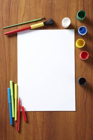 Back to School pupils art pad paints and pens on wooden school desk from aboveの写真素材