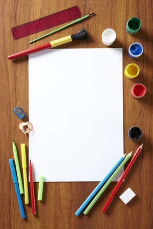Back to School pupils art pad paints pencils and pens on wooden school desk from aboveの写真素材