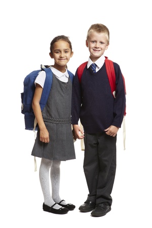 8 year old school boy and girl with backpacks smiling on white backgroundの写真素材