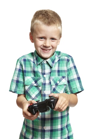 8 year old boy playing games console holding controller on white backgroundの写真素材