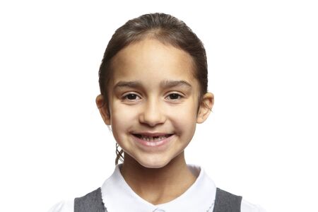 8 year old school girl smiling on white backgroundの写真素材