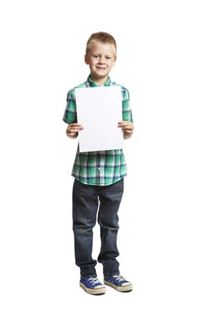 8 year old school boy with blank notepad on white backgroundの写真素材
