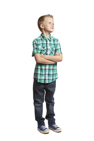 8 year old school boy looking up on white backgroundの写真素材