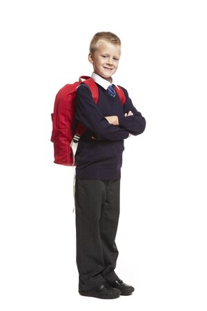 8 year old school boy arms folded with backpack on white backgroundの写真素材