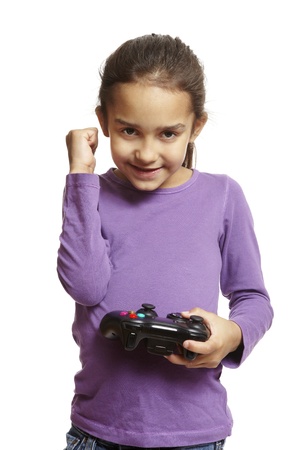 8 year old girl playing games console holding controller on white backgroundの写真素材