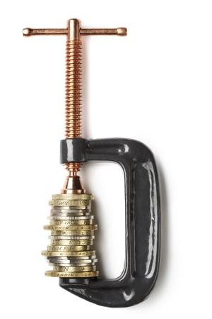 Coin Currency being squeezed in clamp isolated on white backgroundの写真素材