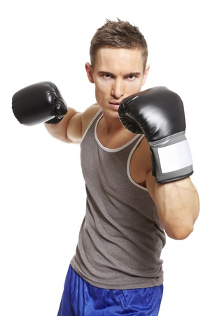 Muscular young man with boxing gloves in sports outfit on white backgroundの写真素材