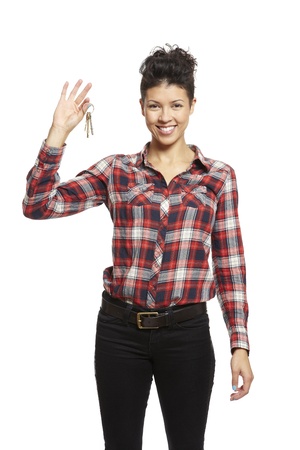 Young woman holding set of house keys on white background smilingの写真素材