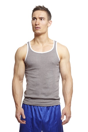 Muscular young man in sports outfit on white backgroundの写真素材