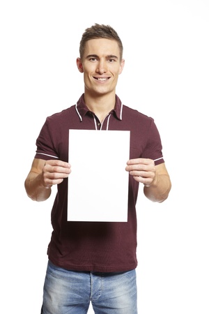 Young man holding blank card on white background smilingの写真素材