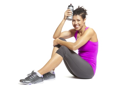 Young woman relaxing in sports outfit smiling on white backgroundの写真素材