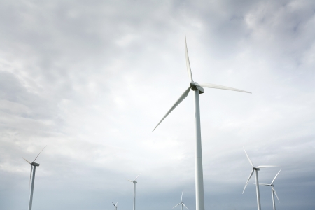 Wind Turbines in wind farm against cloudy skyの写真素材