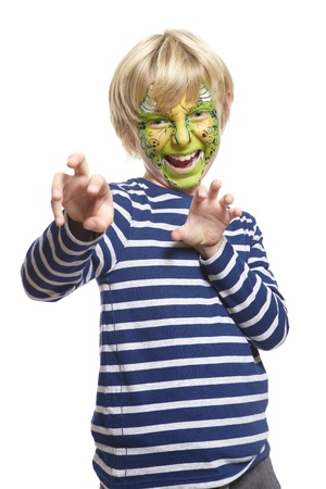 Young boy with face painting monster smiling on white backgroundの写真素材