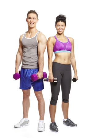 Young man and woman exercising in sports outfits on white background smiling の写真素材