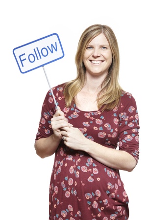 Young woman holding a social media sign smiling on white backgroundの写真素材