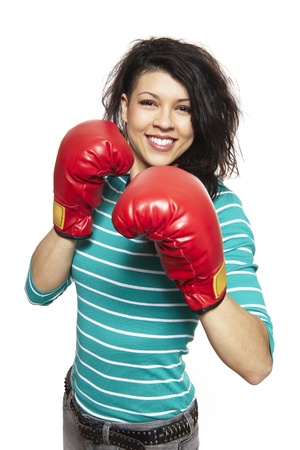Young woman wearing boxing gloves smiling on white backgroundの写真素材