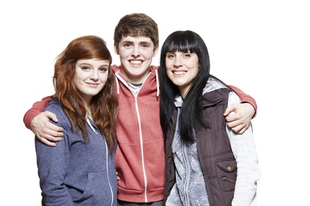 Teenage siblings smiling on white backgroundの写真素材