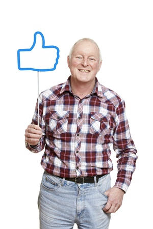 Senior man holding a social media sign smiling on white backgroundの写真素材
