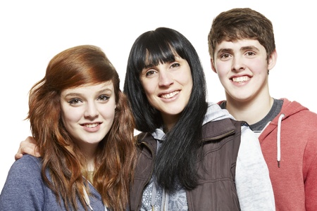 Teenage siblings smiling on white backgroundの写真素材