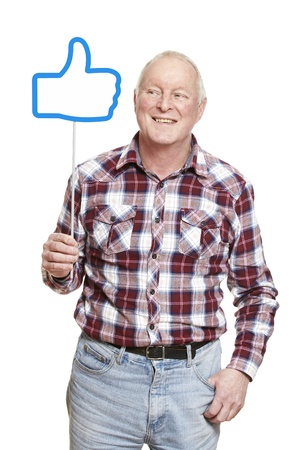 Senior man holding a social media sign smiling on white backgroundの写真素材