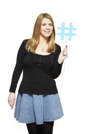 Young woman holding a social media sign smiling on white backgroundの写真素材