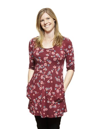 Casually dressed young pregnant woman smiling on white backgroundの写真素材