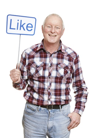 Senior man holding a social media sign smiling on white backgroundの写真素材