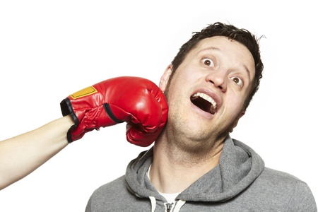 Young couple fighting with boxing gloves smiling on white backgroundの写真素材