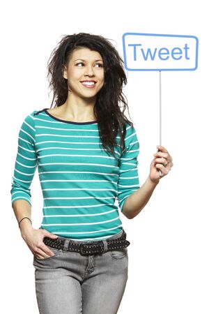 Young woman holding a social media sign smiling on white backgroundの写真素材