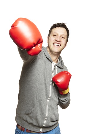 Man wearing boxing gloves smiling on white backgroundの写真素材