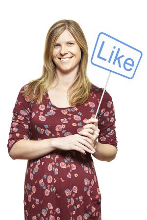 Young woman holding a social media sign smiling on white backgroundの写真素材