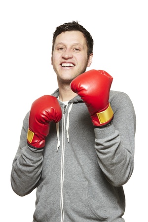 Man wearing boxing gloves smiling on white backgroundの写真素材