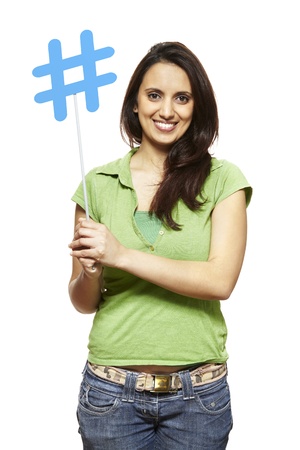 Young asian woman holding a social media sign smiling on white backgroundの写真素材
