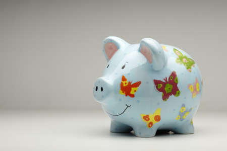 Colourful ceramic piggy bank isolated on plain backgroundの写真素材