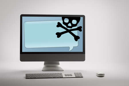 Desktop computer displaying conceptual internet fraud and scam warning on screenの写真素材