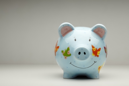 Colourful ceramic piggy bank isolated on plain backgroundの写真素材