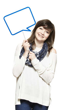 Young woman holding a speech bubble sign smiling on white backgroundの写真素材
