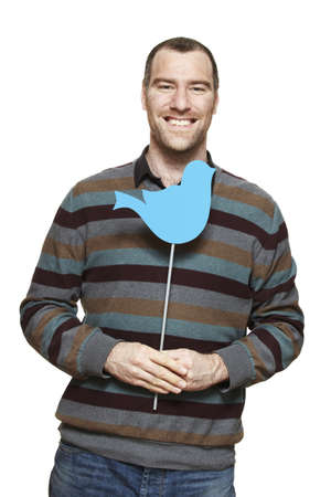 Young man holding a social media sign smiling on white backgroundの写真素材