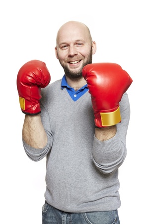 Man wearing boxing gloves smiling on white backgroundの写真素材