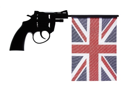 Gun crime concept of hand pistol showing the flag of united kingdomの写真素材