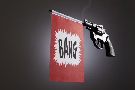 Gun crime concept of hand pistol showing a bang flag
