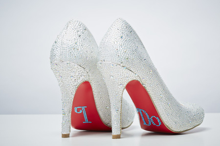 Bridal wedding shoes with I do message on sole isolated on white background. Marriage conceptの写真素材