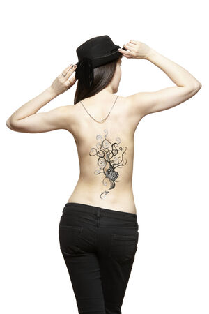 Body art temporary tattoo on female back isolated on white backgroundの写真素材