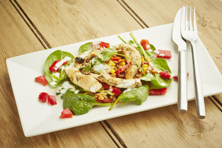 Chicken salad on white dish and wooden table topの写真素材