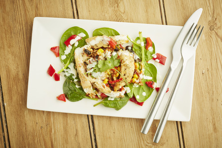 Chicken salad on white dish and wooden table topの写真素材