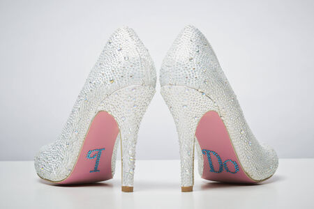 Bridal wedding shoes with I do message on sole isolated on white background. Marriage conceptの写真素材