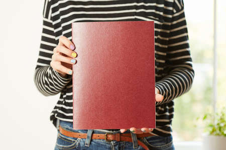 Female hands holding book with empty copy space. Student education conceptの写真素材