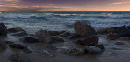 rocky shore view from beachの写真素材